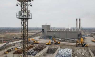 Kamera monitoringu przemysłowego nadzorująca plac magazynowy z posegregowanymi odpadami.
